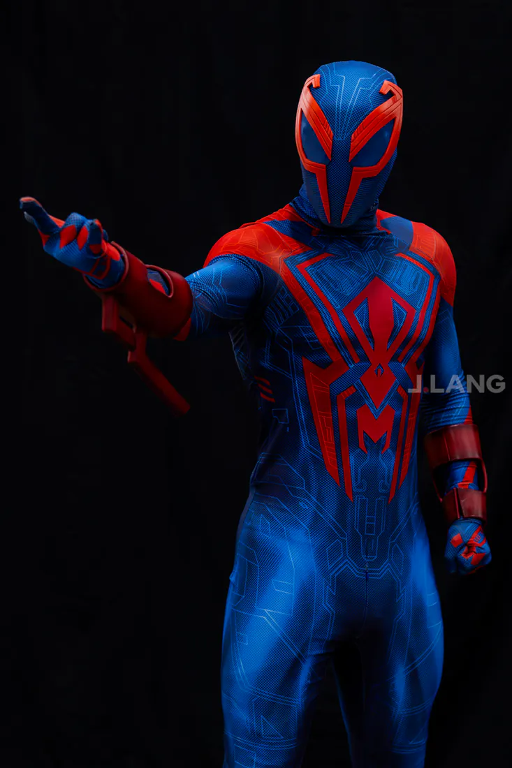 Spider-Man 2099 cosplayer stretches one arm outward, standing tall against a black backdrop